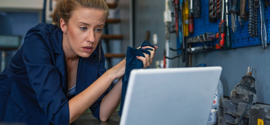 female-mechanic-looking-at-laptop Female mechanic looking at laptop.