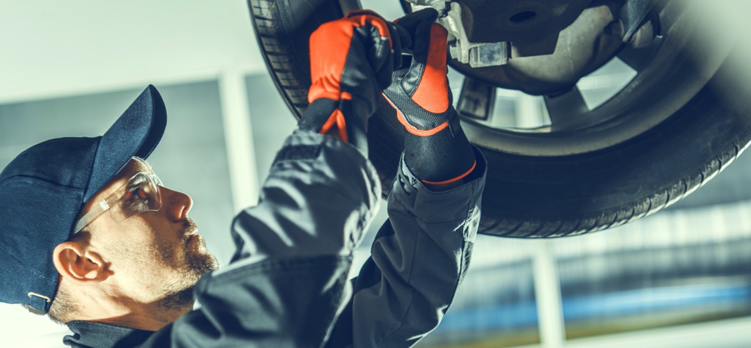 technician-working-on-car-suspension Technician workin on car suspension