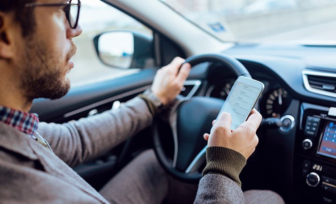 driver-using-phone-in-car
