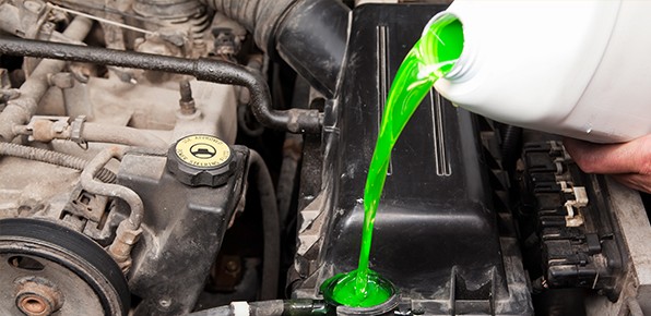 Coolant-Pouring-Into-Car-Engine